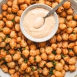 Bloomin onion bites on a plate with comeback sauce.