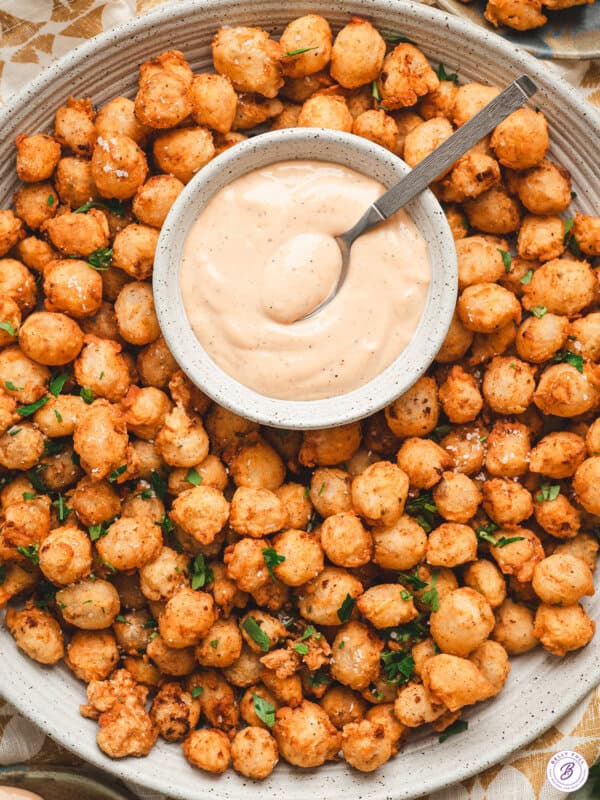 Bloomin onion bites on a plate with comeback sauce.