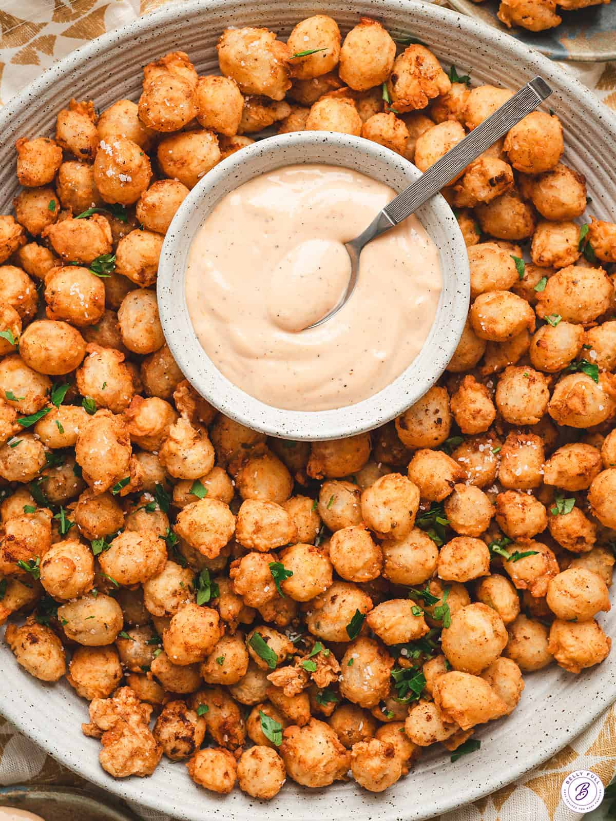 Bloomin onion bites on a plate with comeback sauce.