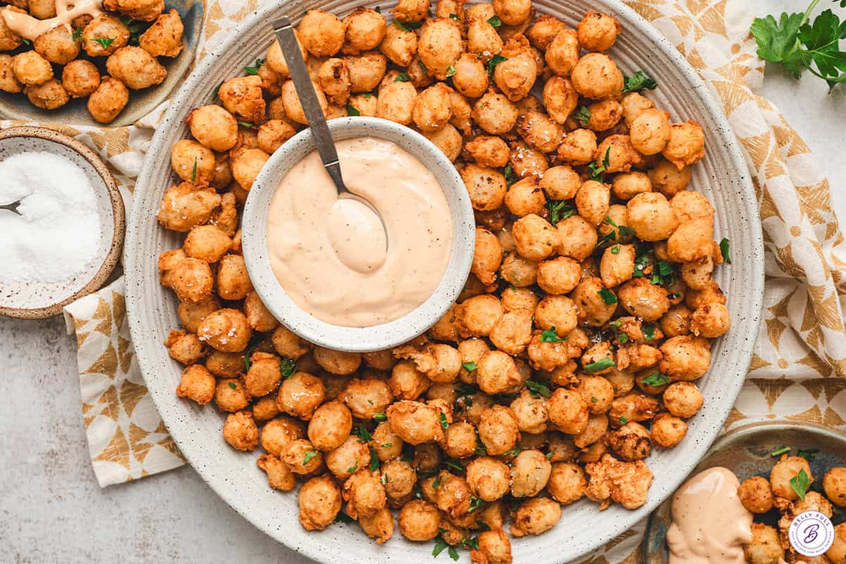 Bloomin onion bites on a plate with comeback sauce.