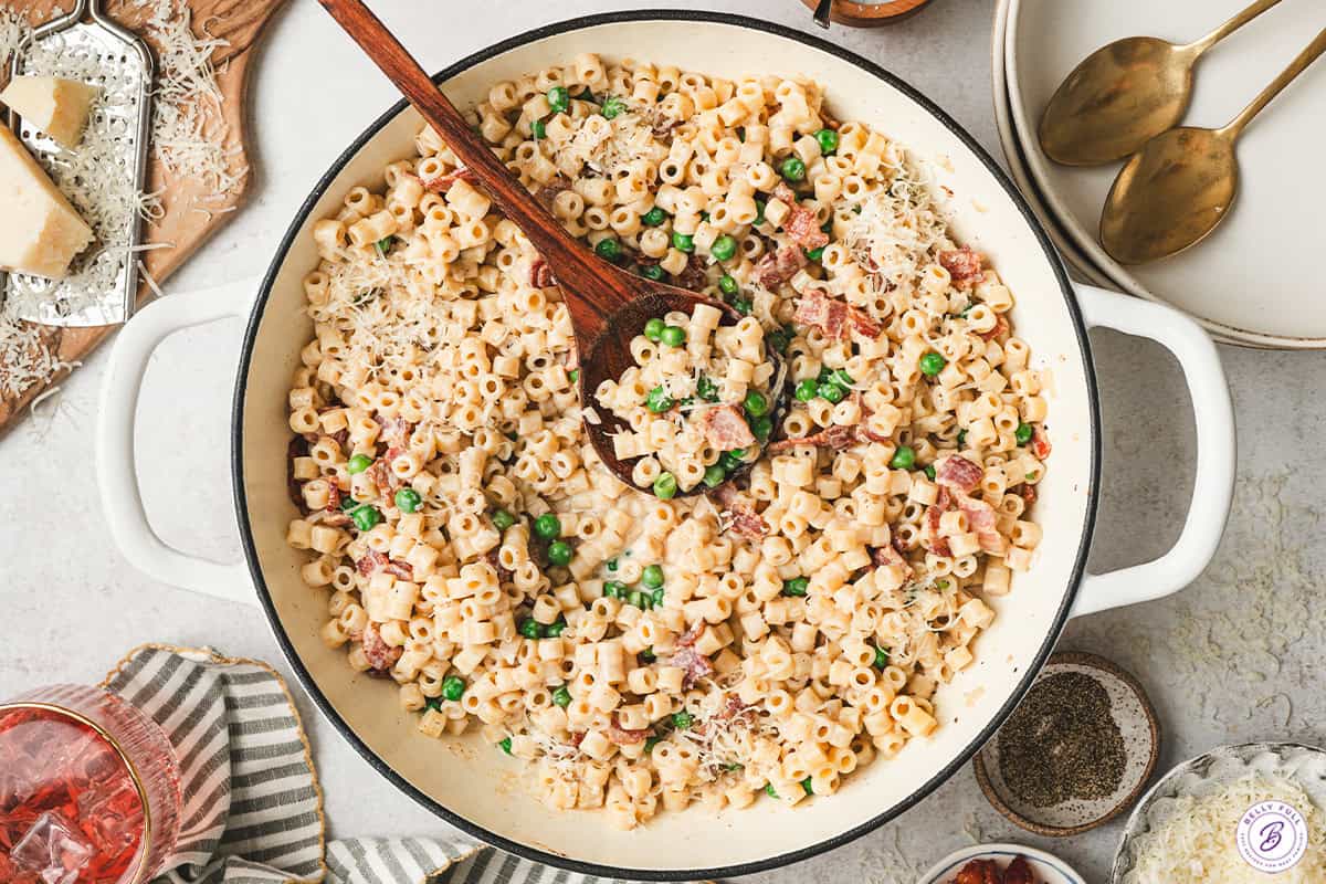 Creamy bacon pea pasta tossed together in a skillet and finished with grated Parmesan cheese.