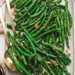 Garlic green beans on a baking sheet.