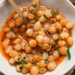 Overhead view of a mini pearl onion bowl in a bowl with a spoon.