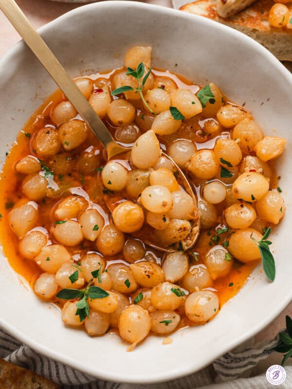 Overhead view of a mini pearl onion bowl in a bowl with a spoon.