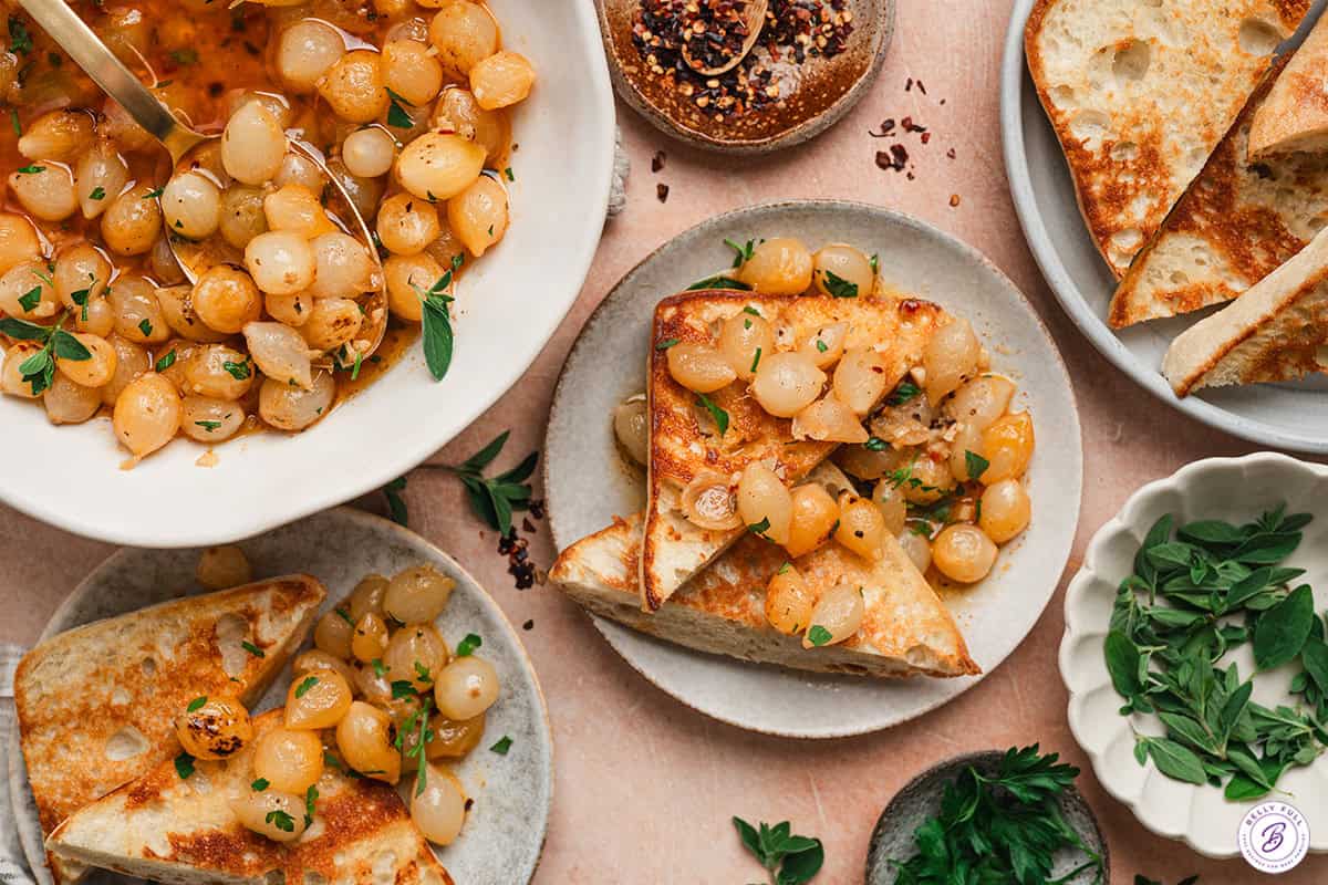 Mini onion boil on toast on a plate.