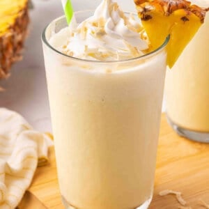 Side view of a glass of pineapple coconut orange julius.