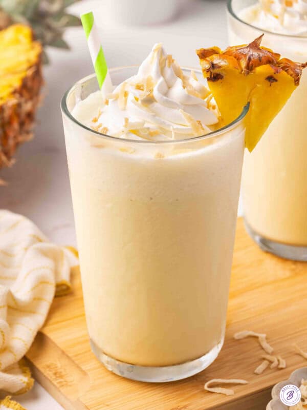 Side view of a glass of pineapple coconut orange julius.