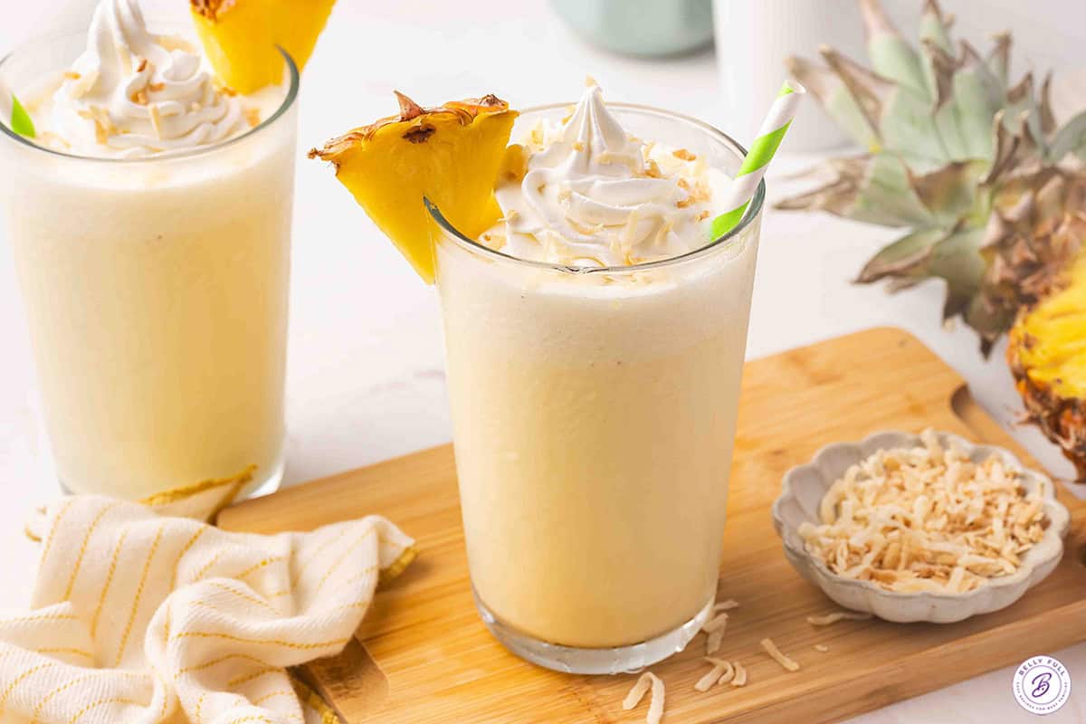 Side view of a pineapple coconut orange julius.