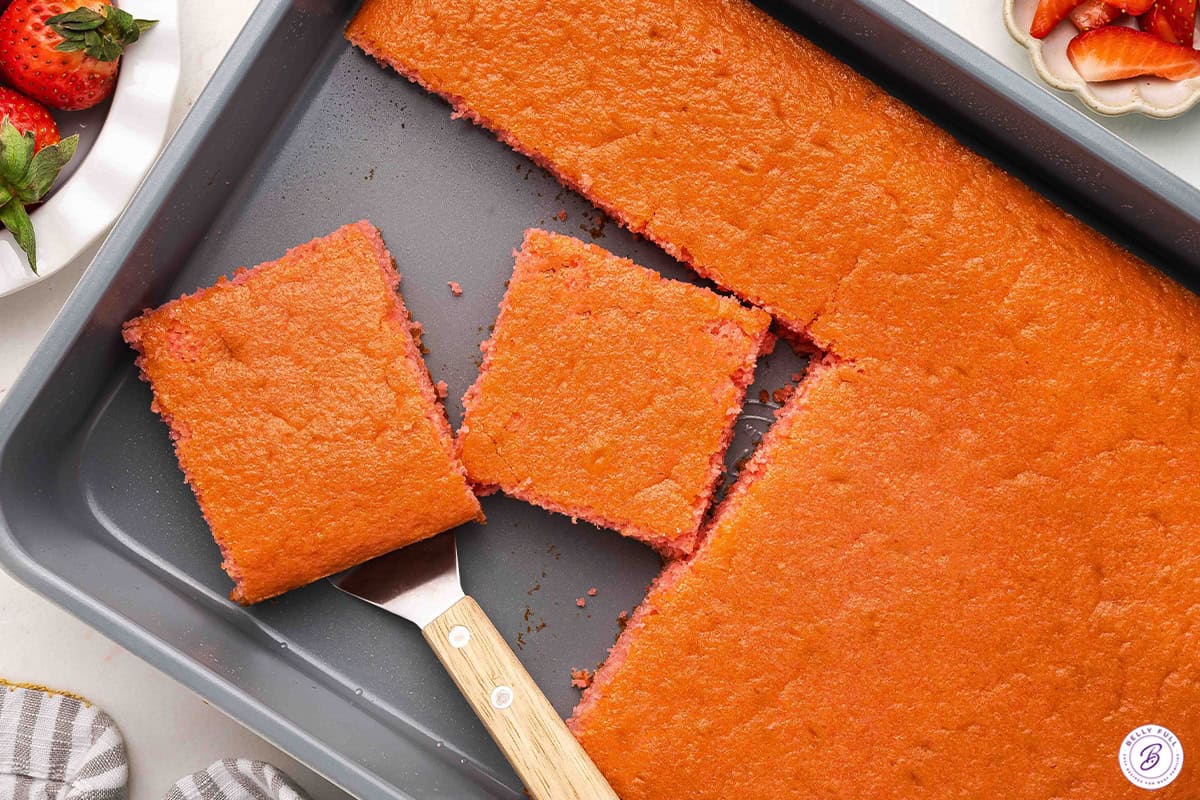 A soda cake in a pan with two square slices.
