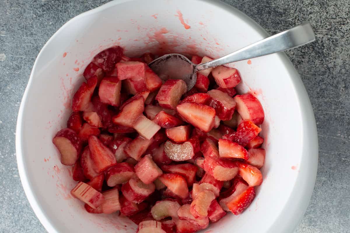 Bowl of chopped strawberries and rhubarb mixed together for strawberry rhubarb pie filling.