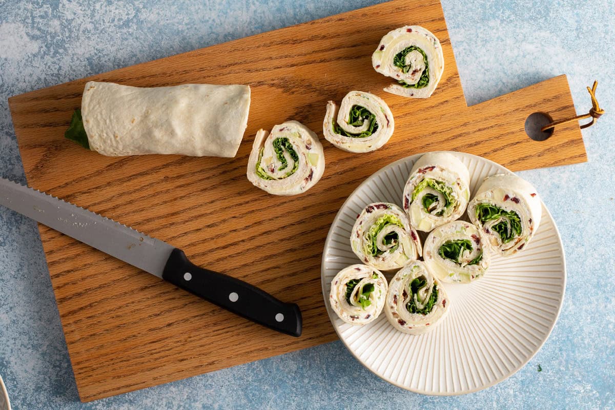 pinwheels appetizer cut into sections on cutting board