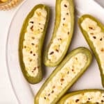 Overhead view of deviled pickles on a plate.
