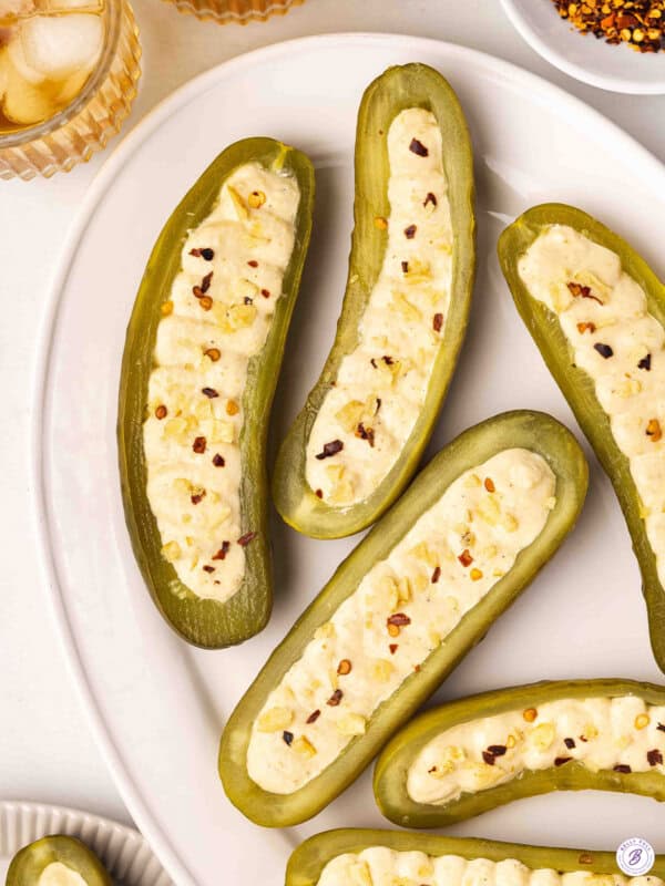 Overhead view of deviled pickles on a plate.