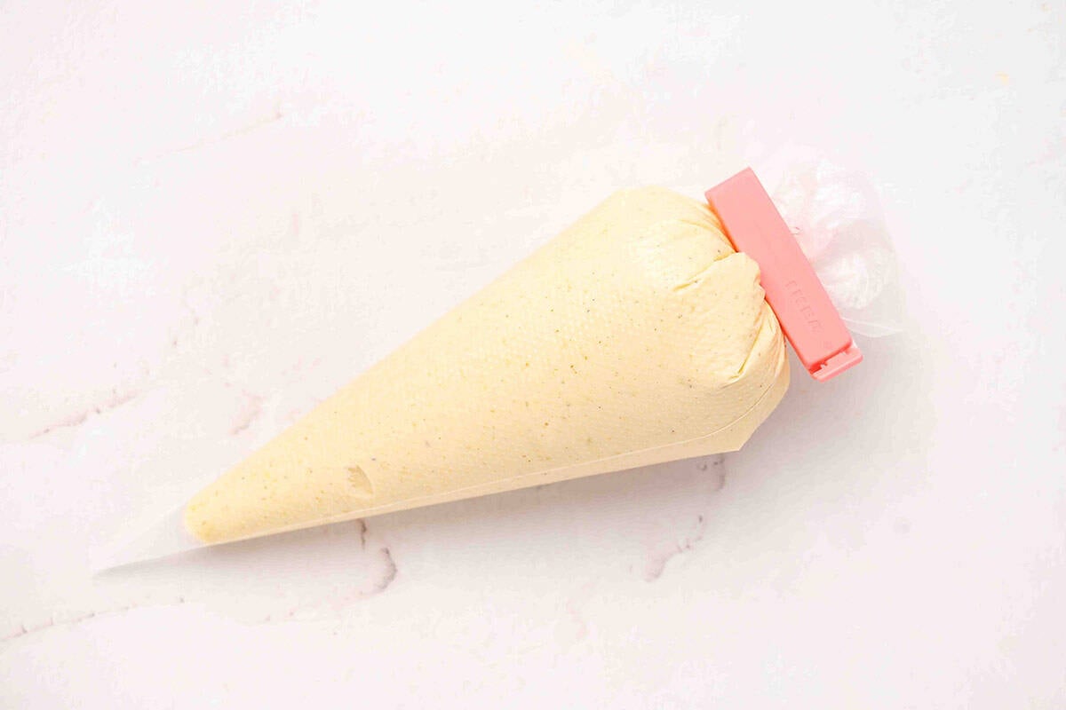The filling for deviled pickles in a piping bag.