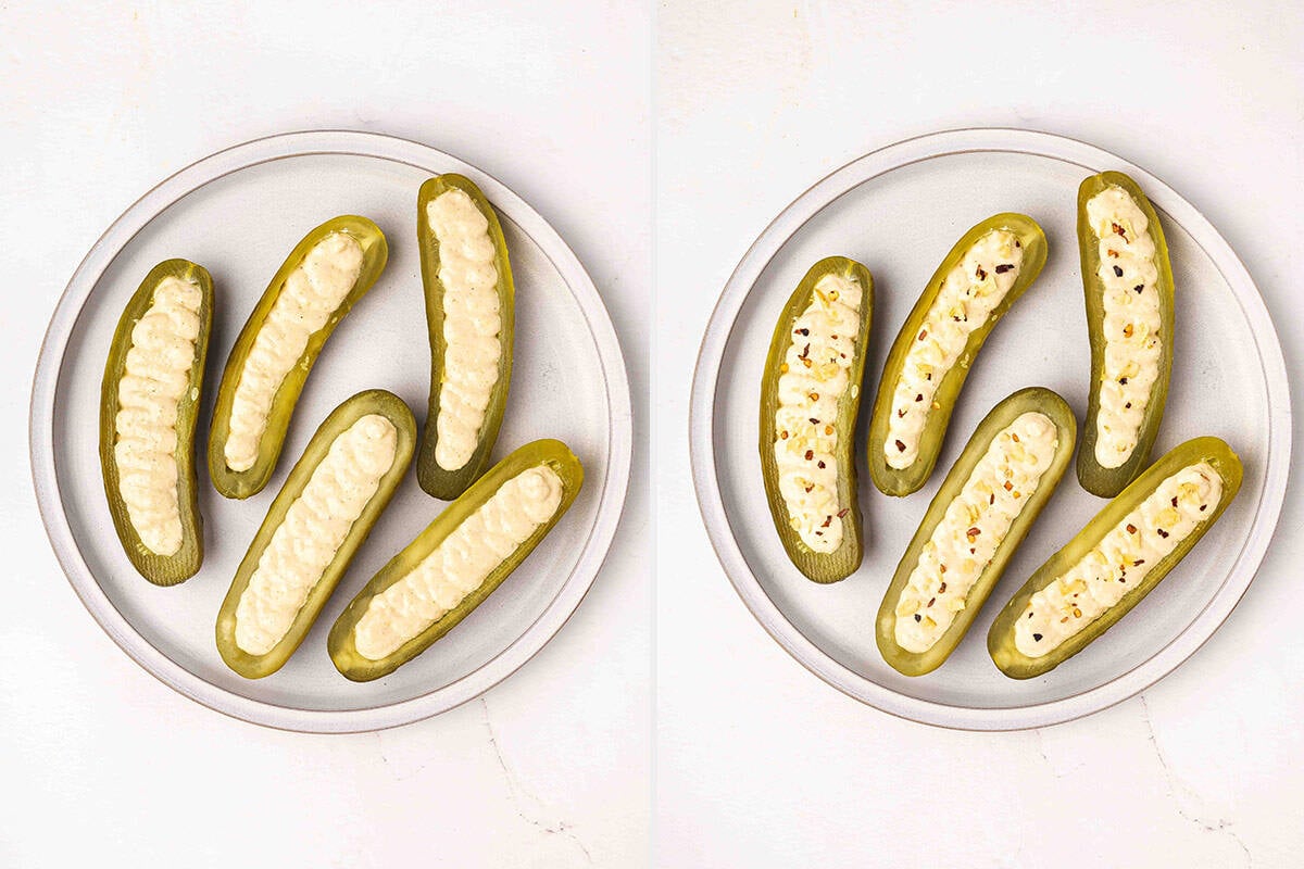 Deviled pickles on a plate with filling added, followed by the pickles topped with crushed potato chips and crushed red pepper flakes.