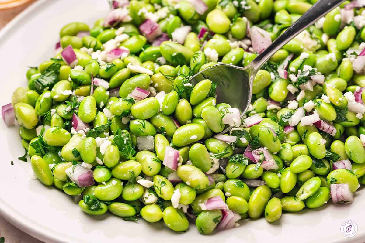 Close up side view of an easy edamame salad on a platter.