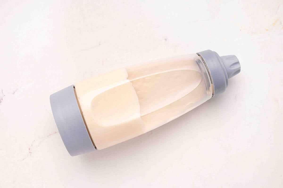 Funnel cake batter in a squeezy bottle.