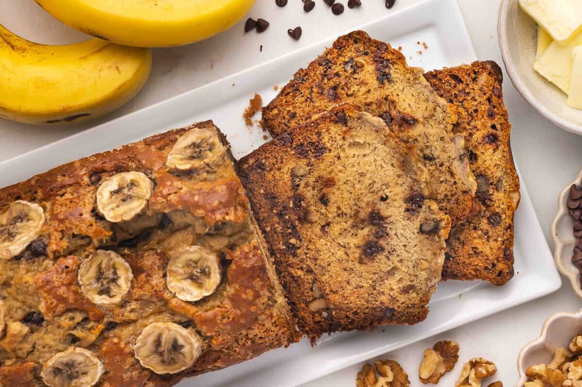 slice of banana bread on a black plate with a fork
