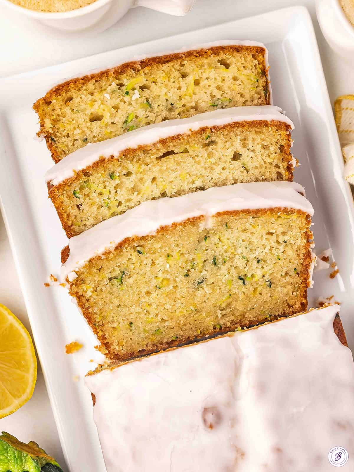 Overhead view of lemon zucchini bread with half cut into slices.