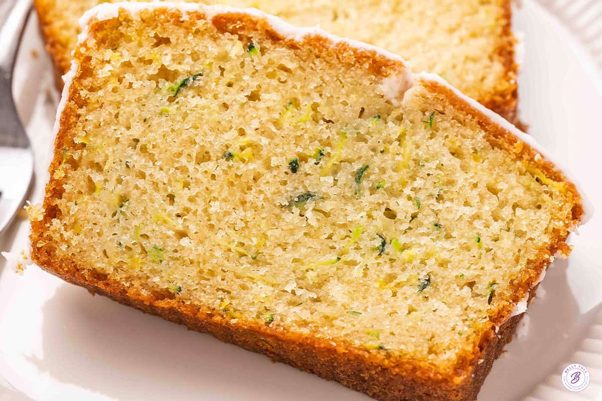An overhead close up of a slice of lemon zucchini loaf.
