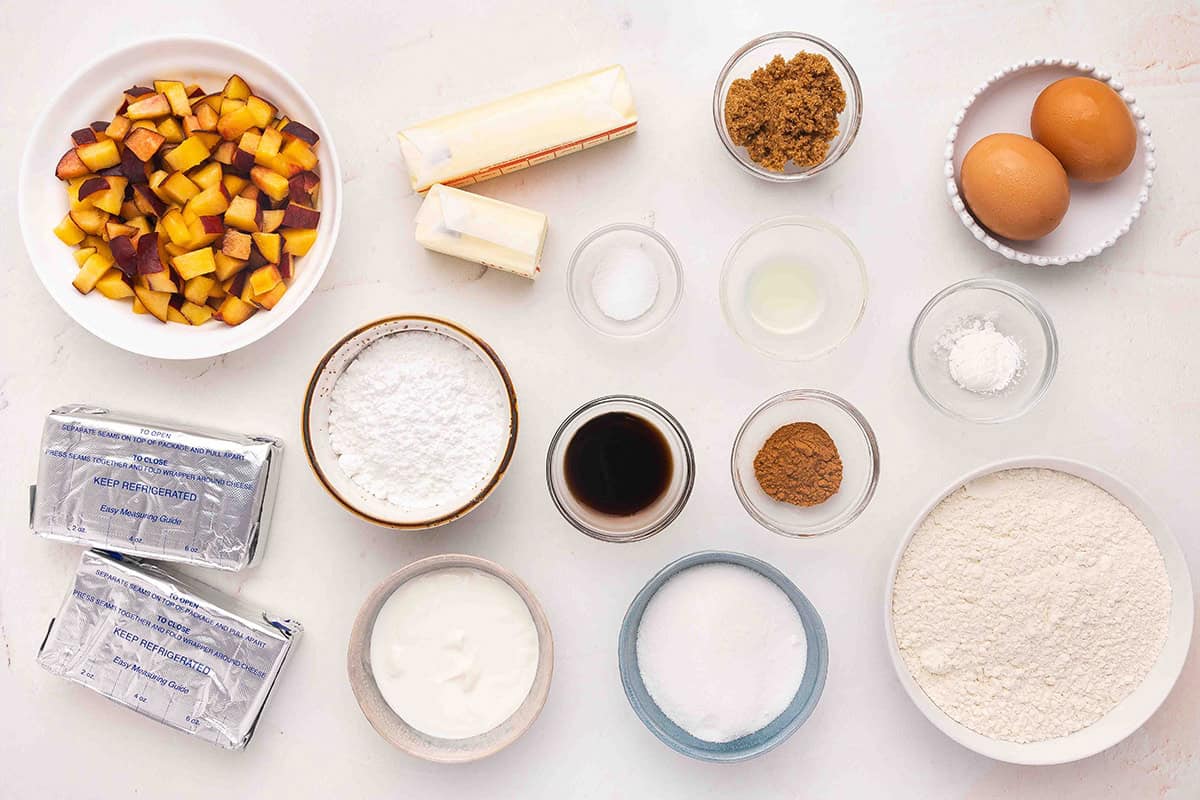 The ingredients to make peach cobbler cheesecake bars.