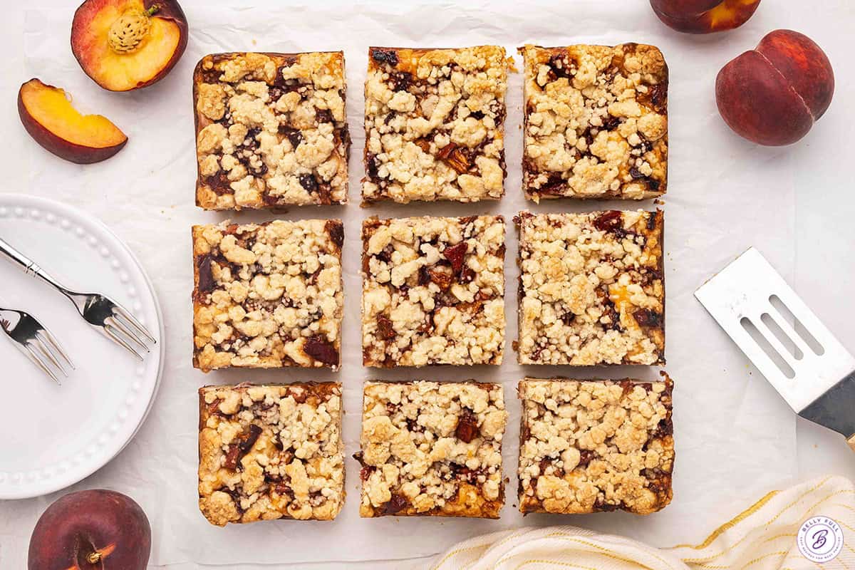 Overhead view of homemade peach cobbler cheesecake bars.
