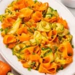 Overhead view of a platter of shaved carrot salad.