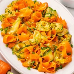 Overhead view of a platter of shaved carrot salad.