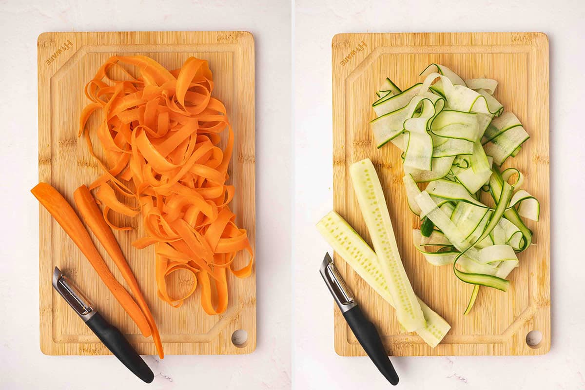 Shaved carrots on a wooden cutting board, followed by shaved cucumber on a cutting board.