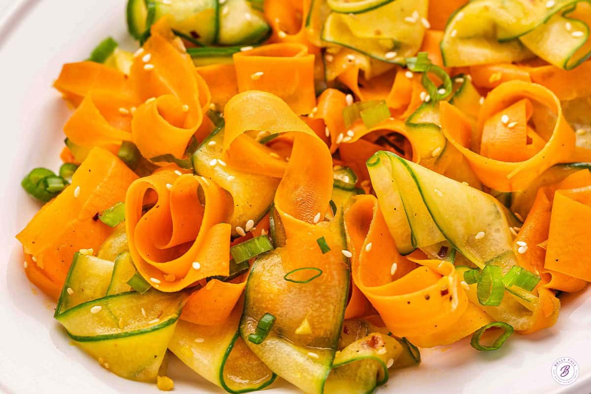 Side view of a shaved carrot salad.