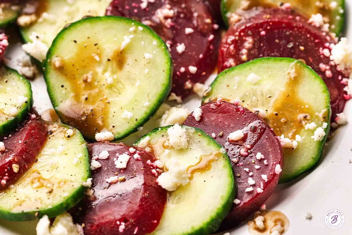 close up of cucumber and beet salad with crumbled feta and balsamic dressing