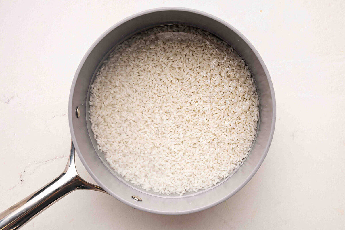 Thai rice in a sauce pan with water.