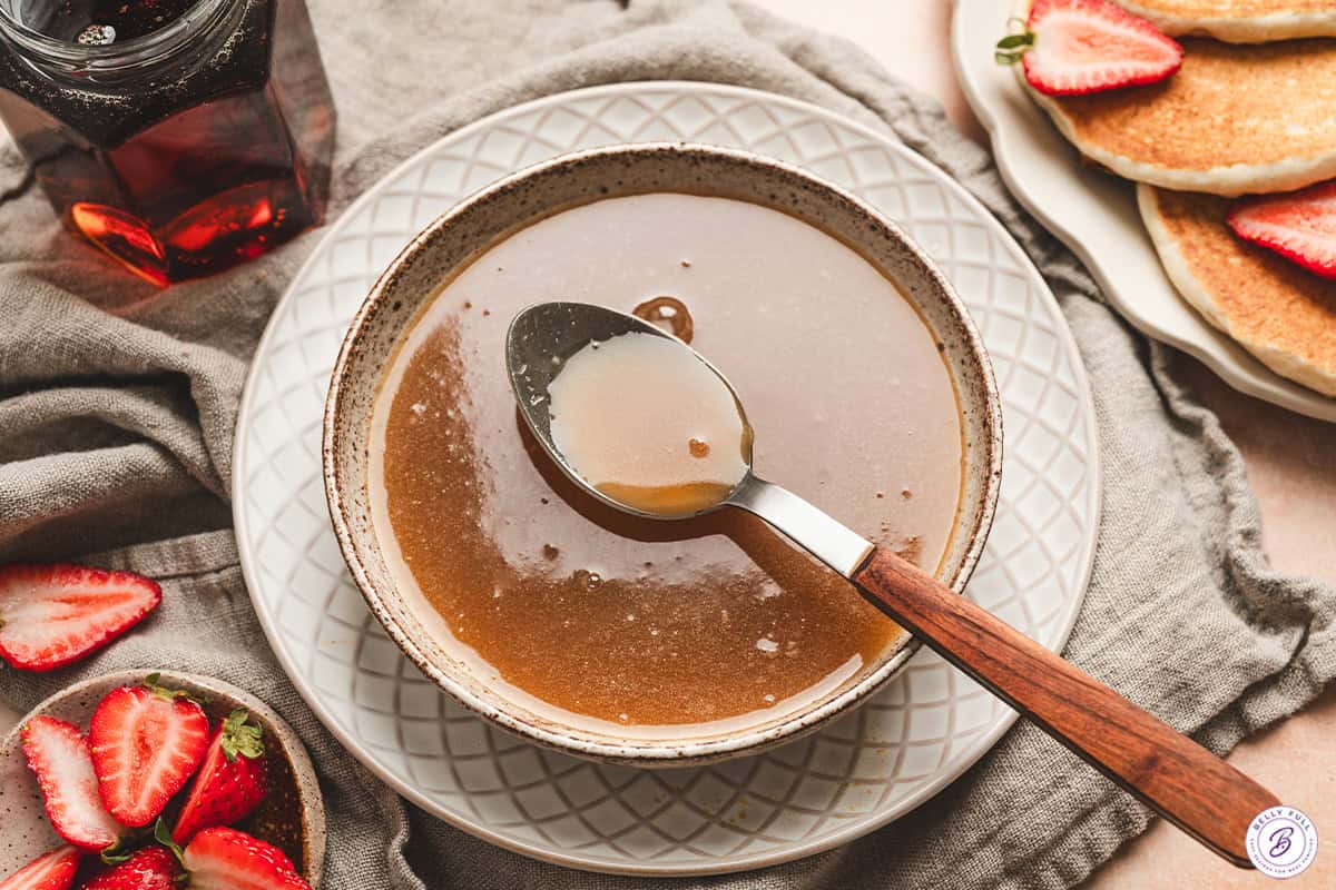 Finished maple butter syrup in a bowl with a spoon.