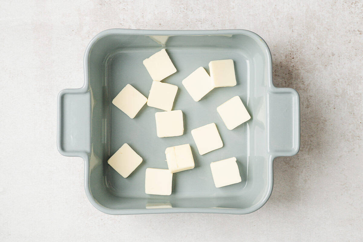 Sliced butter in a baking dish.