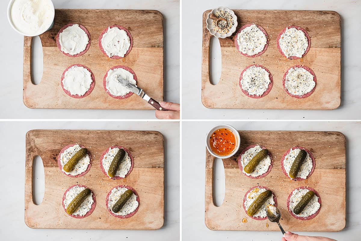 Whipped cream cheese being spread on salami, followed by everything bagel seasoning added, followed by a mini pickle added to the center of the salami, then a spoon drizzling hot honey over the pickle tacos.