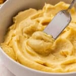 Close up side view of miso butter in a bowl with a knife.