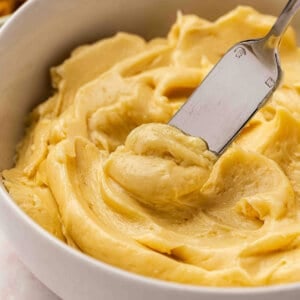 Close up side view of miso butter in a bowl with a knife.