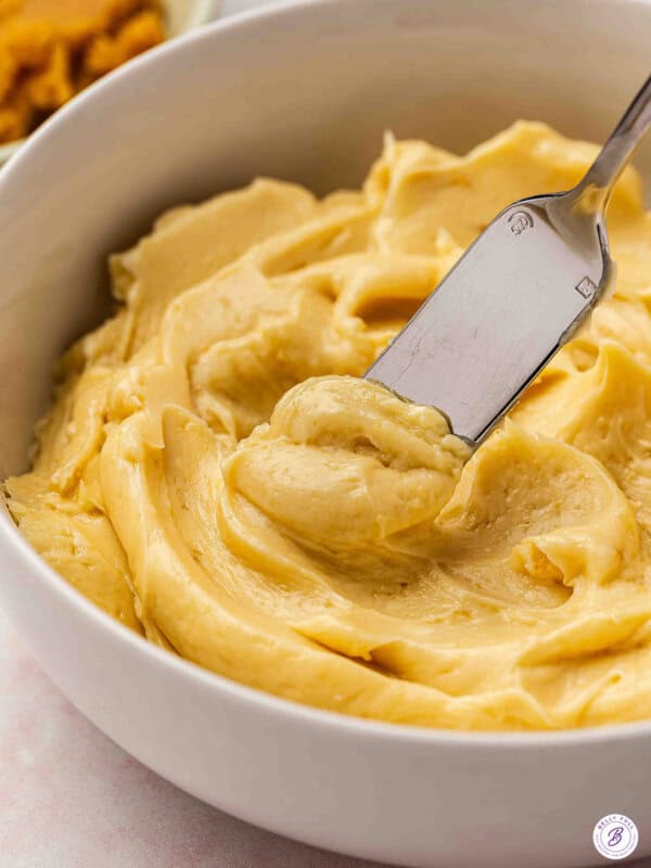 Close up side view of miso butter in a bowl with a knife.