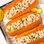 Overhead view of homemade shrimp rolls on a sheetpan.