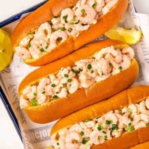 Overhead view of homemade shrimp rolls on a sheetpan.