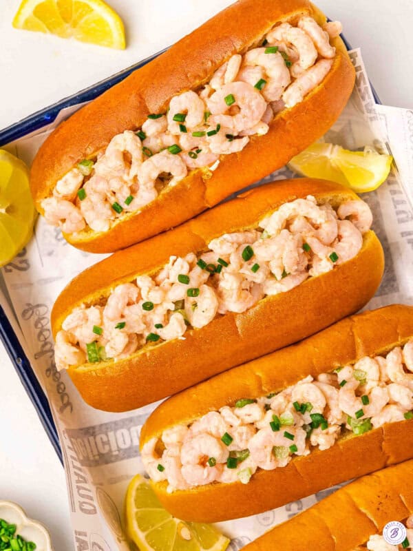 Overhead view of homemade shrimp rolls on a sheetpan.